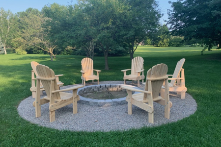 Chairs around a firepit in the backyard